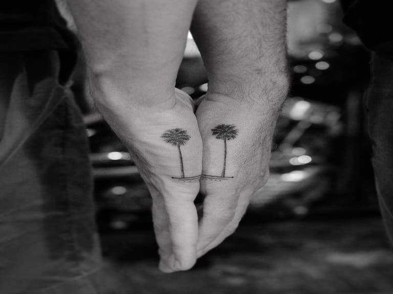 His & His palm tree tattoos by Dr. Woo